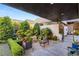 Charming courtyard featuring meticulously manicured greenery, vibrant flowers and stylish seating, creating a serene outdoor space at 671 Scenic Rim Dr, Henderson, NV 89012