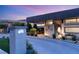 Inviting exterior with unique house numbers, modern lighting and carefully designed landscaping at 671 Scenic Rim Dr, Henderson, NV 89012