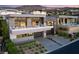 Modern two-story home with clean lines, lush landscaping, and a spacious driveway leading to a two-car garage at 671 Scenic Rim Dr, Henderson, NV 89012