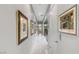 Bright hallway with marble floors and decorative framed art leading to other rooms at 671 Scenic Rim Dr, Henderson, NV 89012