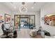 Home office showcasing glass doors opening to a patio, pool, and mountain views at 671 Scenic Rim Dr, Henderson, NV 89012