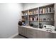 Custom shelving and cabinets with drawers add to the functionality of this home office at 671 Scenic Rim Dr, Henderson, NV 89012