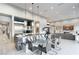 Open-concept kitchen and dining area with modern appliances, sleek design, and seamless flow to the living room at 671 Scenic Rim Dr, Henderson, NV 89012