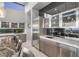 Modern kitchen features sleek cabinets, stainless steel appliances, and a marble countertop breakfast bar with seating at 671 Scenic Rim Dr, Henderson, NV 89012