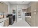 Well-equipped laundry room with sleek cabinets, modern washer and dryer units, and decor at 671 Scenic Rim Dr, Henderson, NV 89012
