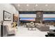 Spacious living room featuring modern decor and a stunning view of the city skyline at sunset at 671 Scenic Rim Dr, Henderson, NV 89012