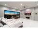 Bright, modern bedroom with a fireplace, large windows displaying city views, and a ceiling fan at 671 Scenic Rim Dr, Henderson, NV 89012