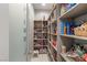 Spacious walk-in pantry with floor-to-ceiling shelves, perfect for organizing food, drinks, and kitchen essentials at 671 Scenic Rim Dr, Henderson, NV 89012