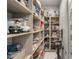 Walk-in pantry with ample shelving and storage for kitchen goods and appliances, with tile flooring at 671 Scenic Rim Dr, Henderson, NV 89012