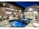Contemporary indoor-outdoor pool area with elegant lounge furniture and city views, perfect for relaxation and entertainment at 671 Scenic Rim Dr, Henderson, NV 89012