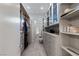 Walk-in closet with custom shelving, drawers, glass cabinets, and ample storage at 671 Scenic Rim Dr, Henderson, NV 89012