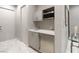 A convenient wet bar features grey cabinets, a sink, a microwave, and a beverage cooler at 671 Scenic Rim Dr, Henderson, NV 89012