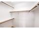 Walk-in closet featuring white walls and shelving with wood closet rods for clothes storage at 7021 Feather Pine St, Las Vegas, NV 89131