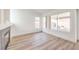 Bright living room featuring a fireplace, new wood floors, and large windows at 7021 Feather Pine St, Las Vegas, NV 89131