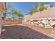 Spacious backyard featuring rock landscaping, brick perimeter walls and wrought iron gate access at 7621 Breed Hill St, Las Vegas, NV 89149