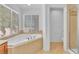 Bright bathroom boasts a corner garden tub with tile surround at 7621 Breed Hill St, Las Vegas, NV 89149