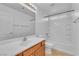 Well-lit bathroom featuring a single vanity, a large mirror and a shower-tub combination with tiled walls at 7621 Breed Hill St, Las Vegas, NV 89149