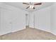 Spacious bedroom featuring two doors, carpet flooring and an overhead ceiling fan at 7621 Breed Hill St, Las Vegas, NV 89149