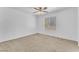 Bright bedroom featuring a ceiling fan and a window with horizontal blinds for natural light and privacy at 7621 Breed Hill St, Las Vegas, NV 89149