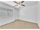Bright bedroom features a ceiling fan and large window with blinds at 7621 Breed Hill St, Las Vegas, NV 89149