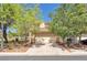 Charming two-story home featuring a tile roof, desert landscaping, and an attached two-car garage at 7621 Breed Hill St, Las Vegas, NV 89149