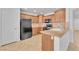 Well-lit kitchen featuring wood cabinets, granite countertops, and modern black appliances at 7621 Breed Hill St, Las Vegas, NV 89149