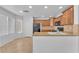 Bright eat-in kitchen with wood cabinets, granite countertops, and tile flooring at 7621 Breed Hill St, Las Vegas, NV 89149