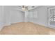 Bright living room featuring tile flooring, ceiling fan, and door to backyard at 7621 Breed Hill St, Las Vegas, NV 89149