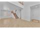 Bright living room with neutral colors, tile flooring, and staircase leading to the second floor at 7621 Breed Hill St, Las Vegas, NV 89149