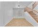 Bright living room featuring tile flooring and staircase with wooden banister at 7621 Breed Hill St, Las Vegas, NV 89149