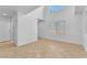 Bright open-concept living room with a high ceiling, tile flooring, and large window at 7621 Breed Hill St, Las Vegas, NV 89149