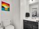 Stylish half bath features modern fixtures and a decorative painting at 8949 Merry Mullion Ct, Las Vegas, NV 89149