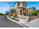 Two-story home with stucco exterior, wrought iron railing, and low maintenance landscaped yard at 8949 Merry Mullion Ct, Las Vegas, NV 89149