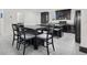 Eat-in kitchen with gray tile flooring, dark cabinetry, and stainless steel appliances at 8949 Merry Mullion Ct, Las Vegas, NV 89149