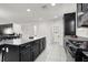 Modern kitchen features dark cabinetry, granite countertops, and stainless steel appliances at 8949 Merry Mullion Ct, Las Vegas, NV 89149