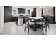 Eat-in kitchen with dark cabinetry, center island, and stainless steel appliances at 8949 Merry Mullion Ct, Las Vegas, NV 89149