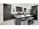 Modern kitchen with gray countertops, black cabinets, and stainless steel appliances at 8949 Merry Mullion Ct, Las Vegas, NV 89149