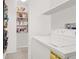 Laundry area with appliances next to a pantry with shelving at 8949 Merry Mullion Ct, Las Vegas, NV 89149