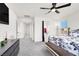 Bright main bedroom features a ceiling fan, multiple windows and modern decor at 8949 Merry Mullion Ct, Las Vegas, NV 89149
