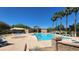 Community pool featuring lounge chairs, palm trees, clear skies, and a refreshing swimming space at 8949 Merry Mullion Ct, Las Vegas, NV 89149