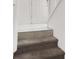 Stairway with taupe colored carpet and white baseboards at 8949 Merry Mullion Ct, Las Vegas, NV 89149