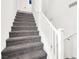 Carpeted stairs with white railing lead to the upper level of this home at 8949 Merry Mullion Ct, Las Vegas, NV 89149