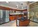 Modern kitchen with stainless steel appliances, wooden cabinets, and a black granite countertop island at 900 Las Vegas Blvd # 912, Las Vegas, NV 89101