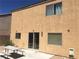 Home's backyard featuring a concrete patio, desert landscape, and a picnic table at 9175 Titan Hill Ct, Las Vegas, NV 89148