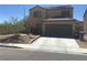 Charming two-story home with a well-maintained front yard and a two-car garage at 9175 Titan Hill Ct, Las Vegas, NV 89148