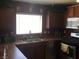 Kitchen features stainless steel appliances, and a view of the backyard from the window above the sink at 9175 Titan Hill Ct, Las Vegas, NV 89148