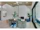 Bright, open living room with fireplace, modern ceiling fan, and large sliding glass doors to the outside at 9425 Villa Ridge Dr, Las Vegas, NV 89134
