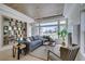 Cozy living room with large windows, stylish furniture, and a decorative bookshelf at 9425 Villa Ridge Dr, Las Vegas, NV 89134