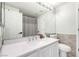 Bathroom featuring a vanity with marble countertop, large mirror, and a toilet at 9440 Grenville Ave, Las Vegas, NV 89134