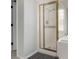 Bathroom featuring a glass-enclosed shower with gold trim and tiled walls at 9440 Grenville Ave, Las Vegas, NV 89134